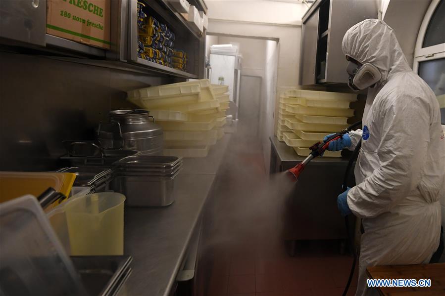 A staff member sprays disinfectant in a restaurant in Rome, Italy, April 22, 2020. The coronavirus pandemic has claimed over 25,000 lives in locked-down Italy, bringing the total number of active infections, fatalities and recoveries so far to 187,327, according to the latest data released by the country's Civil Protection Department on Wednesday. 