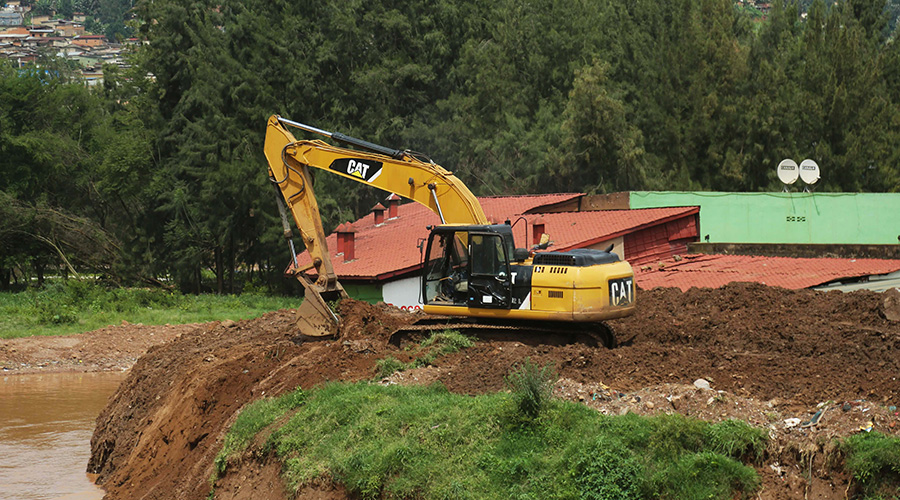 An excavator clears debris from Mpazi drainage to enable direct flow of water into Nyabugogo River on Wednesday, April 22. The works to expand the drainage stalled after the project supervisor was found to have used fraudulent means to obtain the tender. 