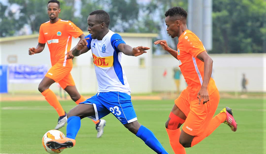 Rayon Sports striker Yannick Bizimana dribbles against AS Kigali players in a past match. It is almost certain that the remaining topflight league fixtures this season will be played behind closed doors, if at all it resumes. Courtesy.