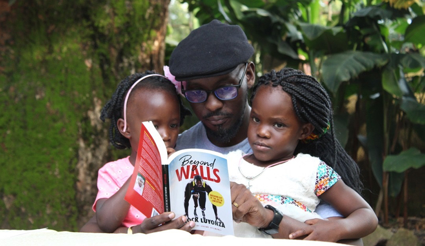 Enock Luyonza reads his book titled u2018Beyond Wallsu2019 to children. / Courtesy.
