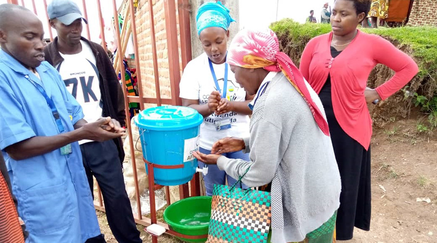 Volunteers help set up hand washing facilities in rural areas to prevent the spread of COVID-19. 
