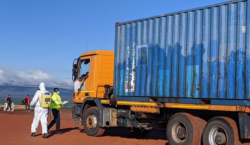 Officials disinfect a cargo truck from Tanzania  at Rusumo One Stop Border Post last week. /Julius Bizimungu.