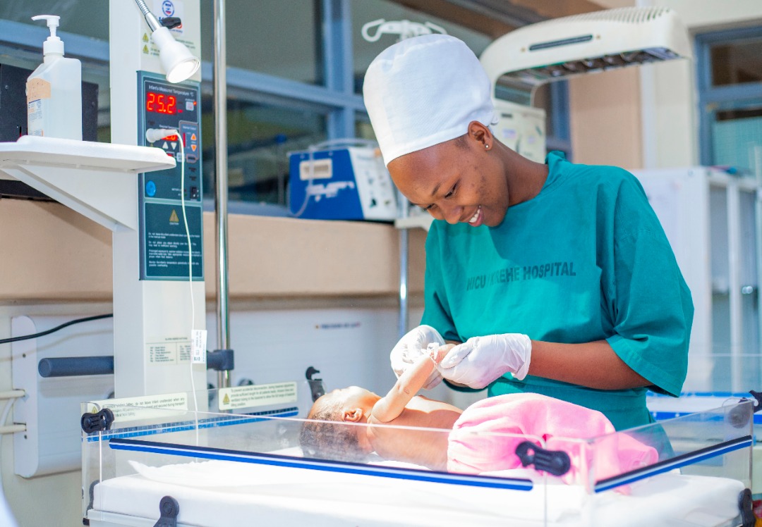 A midwife attends to a new born baby. In 1995, Rwanda had only 5 midwives. Today, there are 2,142. 