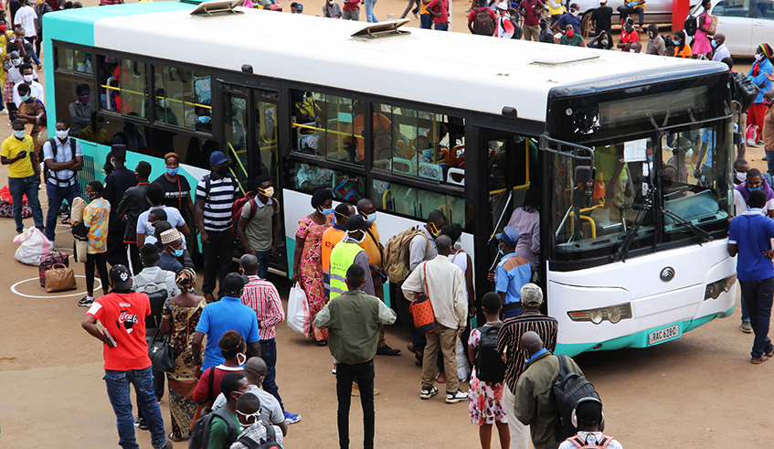 Passengers queue to board a bus at Nyabugogo Taxi Park in Kigali on Monday, May 4. Due to the shortage of buses, many commuters were left stranded at bus parks for hours. / Photo: Craish Bahizi.