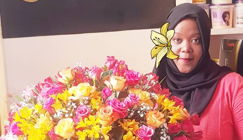 Nadia Uwase, posing for a photo with a bouquet.
