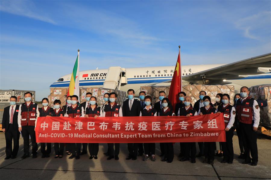 Chinese medical team members and Chinese Ambassador to Zimbabwe Guo Shaochun (C) pose for a photo at Robert Mugabe International Airport in Harare, Zimbabwe, on May 11, 2020. A Chinese medical team arrived in Zimbabwe on Monday to assist the southern African country's efforts in the fight against COVID-19. 