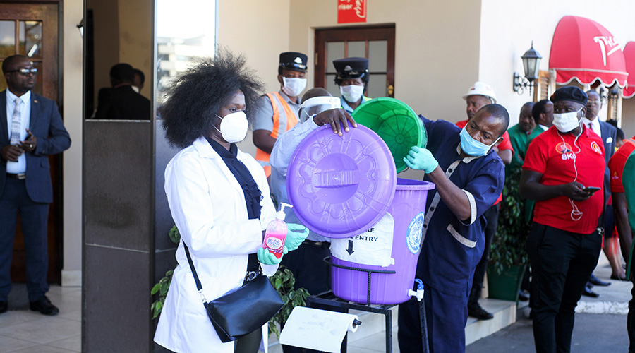 Officials go about their work at the main entrance of Sunbird Mount Soche Hotel during an event for presidential candidates to present their nomination papers in Blantyre, Malawi, May 7, 2020. Malawi is going to host another presidential election on July 2 this year. The development has come amidst a time when almost every country in the world is trying to control public gatherings in fear of COVID-19. 