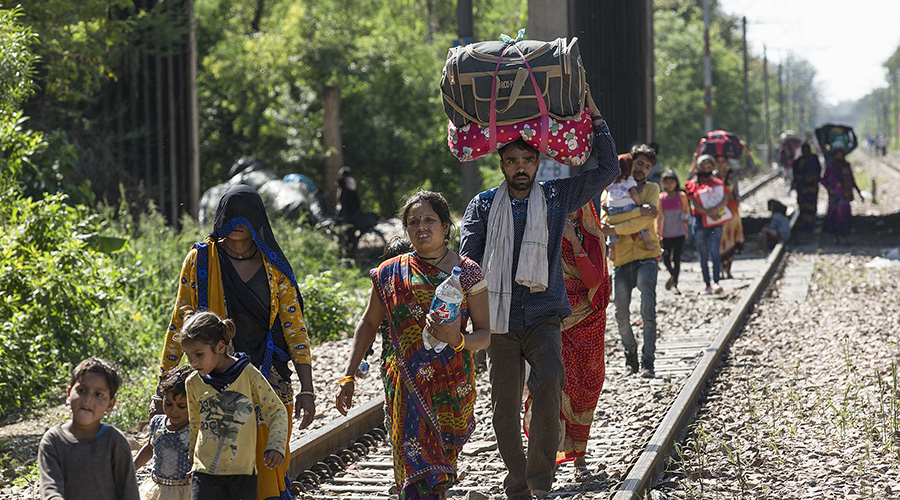 Migrant laborers walk to their villages during the lockdown in New Delhi, India, March 29, 2020. 