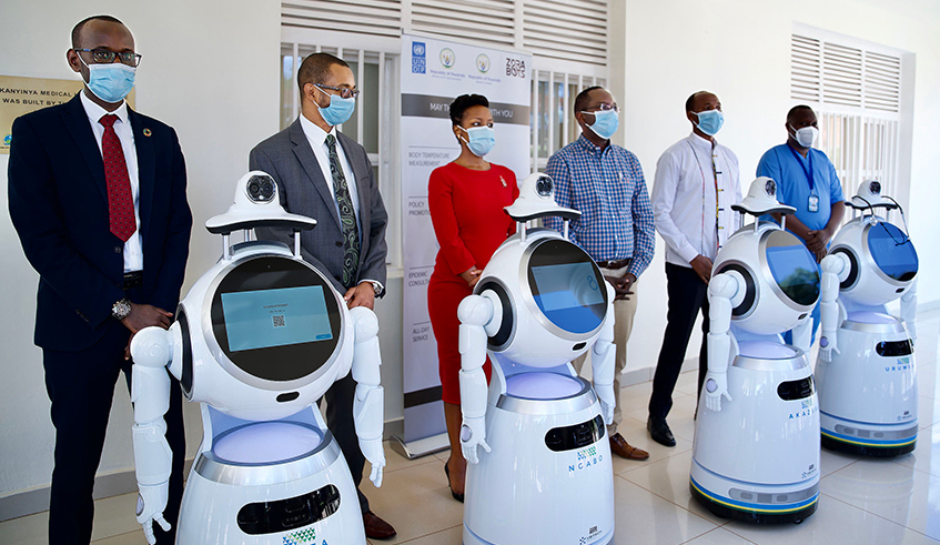 Government officials unveil five high-tech robots to support in the  fight against COVID-19. The robots can perform a number of tasks related to COVID-19 management, including mass temperature screening, delivering food and medication to patients, capturing data, detecting people who are not wearing masks, among others. / Photo: Gad Nshimiyimana.