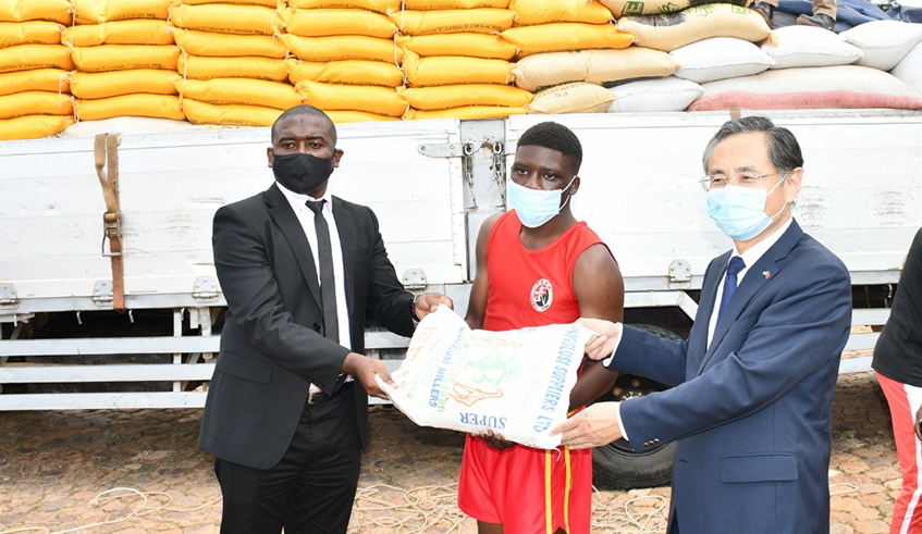 Amb. Rao Hongwei and Maboko deliver food supplies to one of the Kungfu players. / All photos by Craish Bahizi