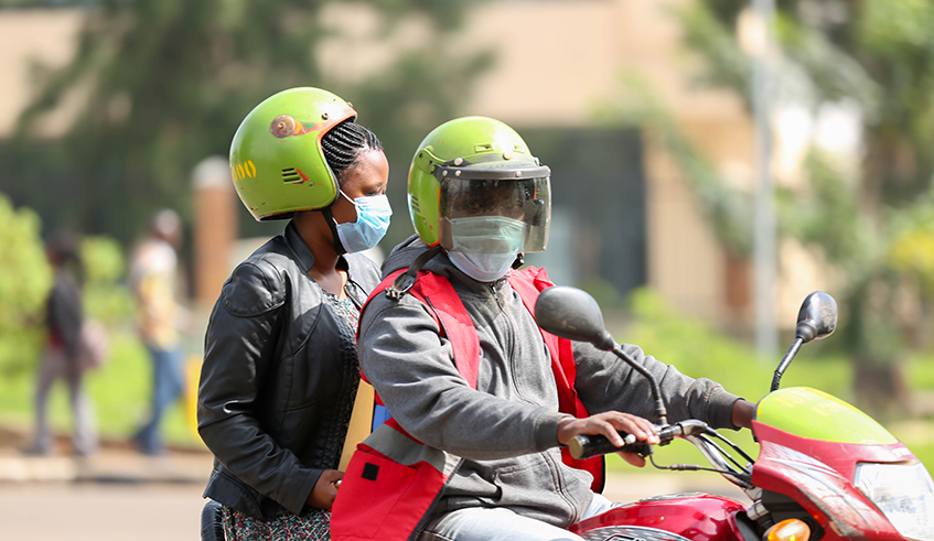 A taxi-moto rider carries a passenger on March 17, 2020. / Photo: File.