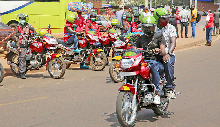 A taxi-moto operator carries a passenger in Kigali on Wednesday, June 3. The motorcyclists returned in operation yesterday after over two months of inactivity due to the Covid-19 lockdown. Some operators reported slow business on day one. / Photo: Craish Bahizi.