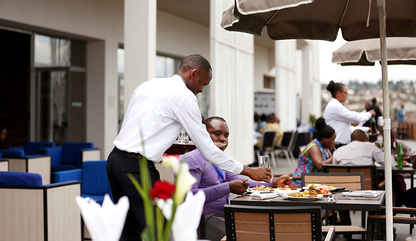 A waiter serves a customer at Onomo Hotel in Kigali on January 10. The private sector was severely affected by Covid-19 pandemic. / Photo: Sam Ngendahimana.