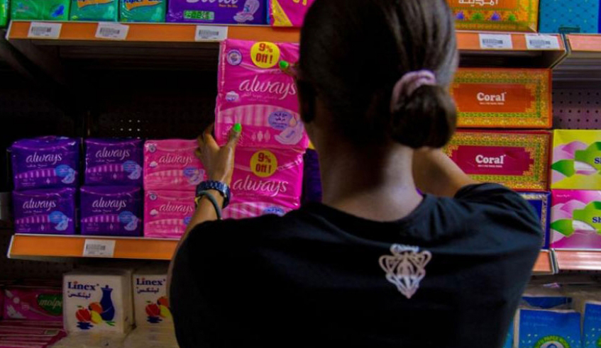 A woman buys sanitary pads in a supermarket in Kigali. / Photo: File.