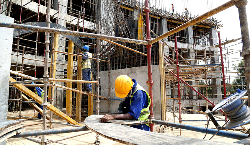 Workers at a construction site of a public building in Kigali. The Institution of Engineers Rwanda has urged government to put more efforts in ensuring adherence to the law regarding safety of the quality of buildings in the country, which they say will go a long way in safeguarding lives. /  Photo: Sam Ngendahimana.
