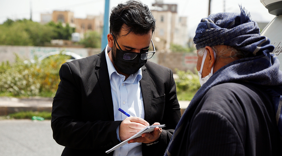Yemeni doctor Sami Yahya al-Hajj (L) gives free medical consultation to a man in a street in Sanaa, Yemen, June 10, 2020. Yemeni doctor Sami Yahya al-Hajj drives along the streets of the capital Sanaa everyday offering free medical consultations for the poor amid the spread of coronavirus in the war-torn country. 