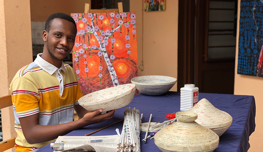 Aimable Mugabo making paper bowls.