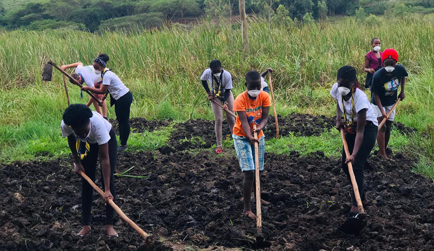 Girl guides cultivating land to plant crops. . / Courtesy photos