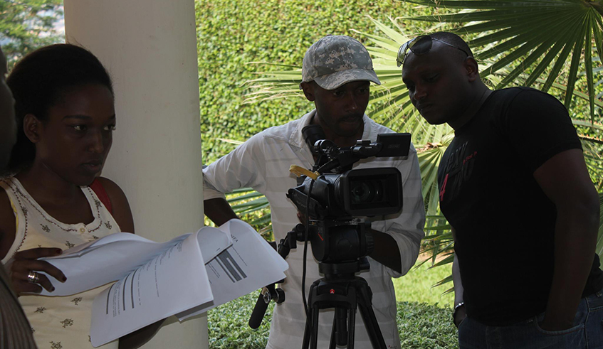 Willy Ndahiro (in a black t-shirt) with the movie crew during a movie shoot in Kigali.  / Courtesy photos.