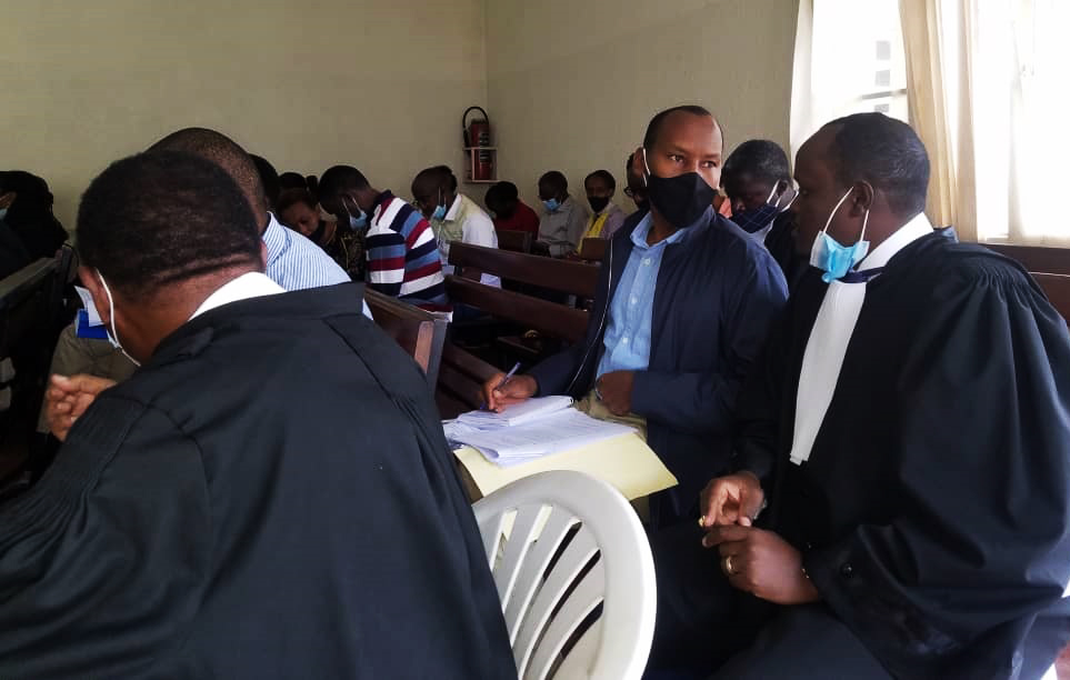 Permanent Secretary in the Ministry of Finance and Economic Planning, Caleb Rwamuganza consults with his Lawyer lawyer Moise Nkundabarashi in Gasabo Primary Court during the bail hearing on Thursday, June 18. 