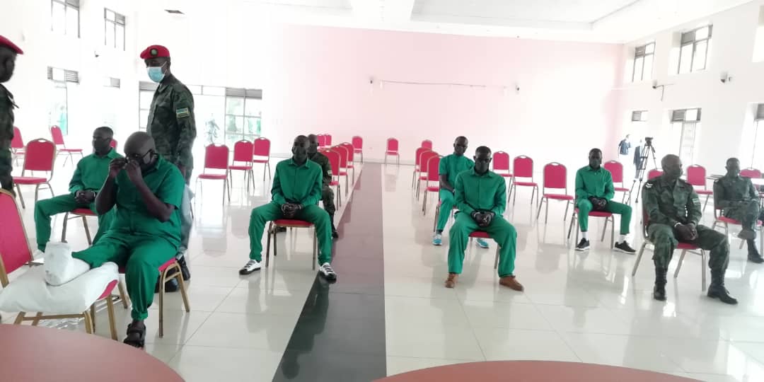Mudathiru consults with his lawyer during the proceeding at the Military High Court. The suspects were spaced to conform to the Covid-19 measures and were all seen wearing face masks.