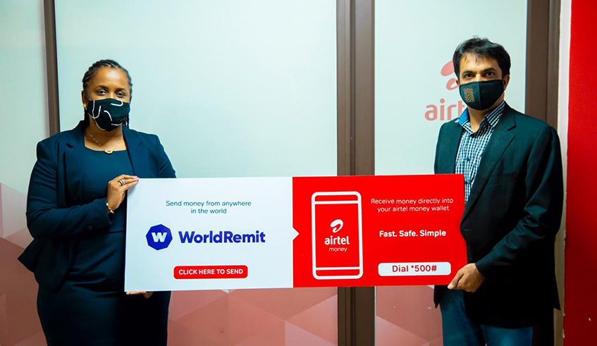 Carine Umurerwa, Country Manager of WorldRemit (left) with Amit Chawla, Airtel Rwanda Managing Director after signing the agreement in Kigali yesterday. / Courtesy.