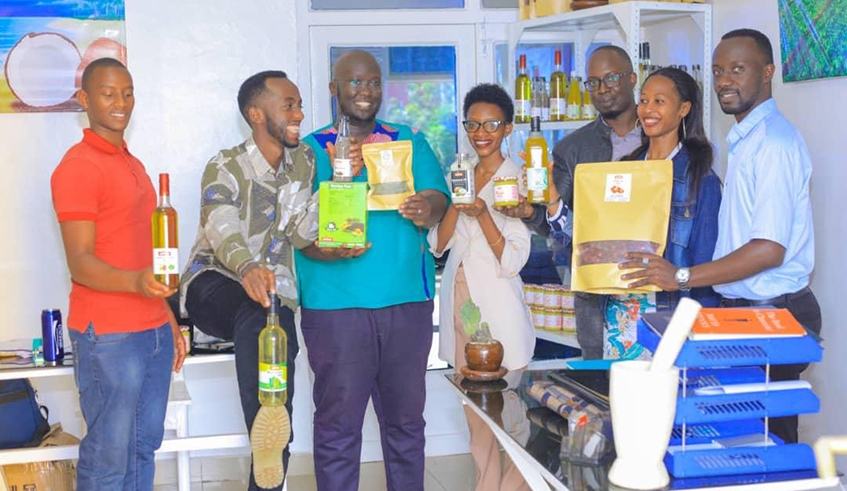 Annick Umutibagirana (centre) and some of her employees while showing off some of their organic skin and haircare products. / Courtesy.