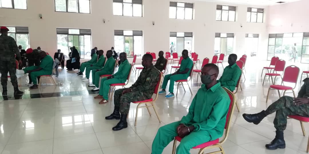 Mudathiru consults with his lawyer during the proceeding at the Military High Court. The suspects were spaced to conform to the Covid-19 measures and were all seen wearing face masks.