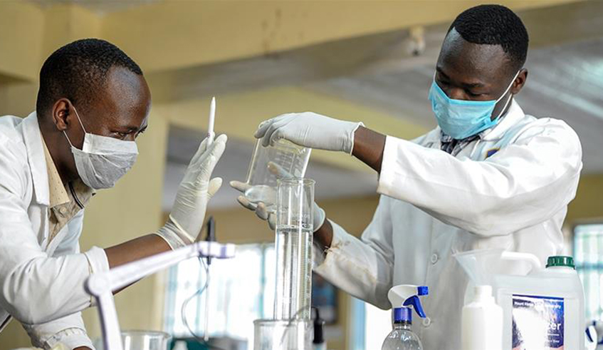 Laboratory technicians run a Covid-19 test in Kigali. / File