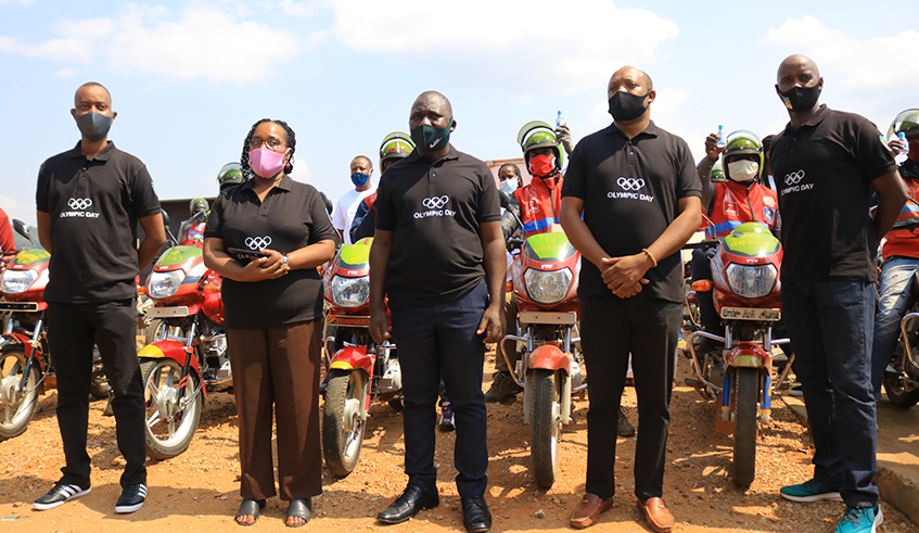 Fu00e9licitu00e9 Rwemalika (2nd-L) and other officials from the Rwandan sports community at the event to donate the hand sanitisers to taxi-moto riders in Downtown, Nyarugenge District, on Tuesday. / Courtesy.