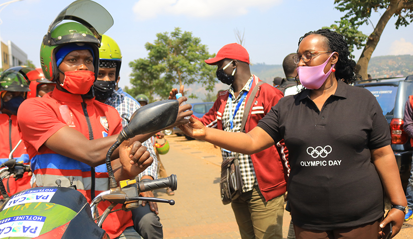 FÃ©licitÃ© Rwemalika (2nd-L) and other officials from the Rwandan sports community at the event to donate the hand sanitisers to taxi-moto riders in Downtown, Nyarugenge District, on Tuesday. / Courtesy.