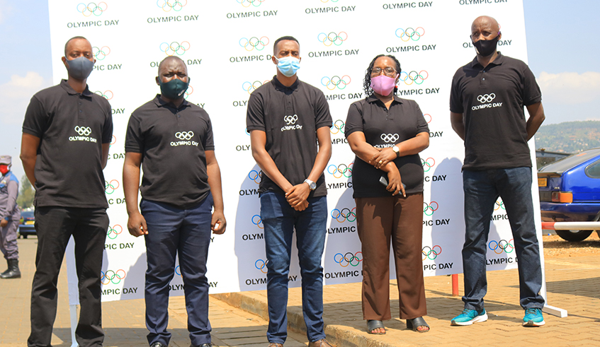 FÃ©licitÃ© Rwemalika (2nd-L) and other officials from the Rwandan sports community at the event to donate the hand sanitisers to taxi-moto riders in Downtown, Nyarugenge District, on Tuesday. / Courtesy.
