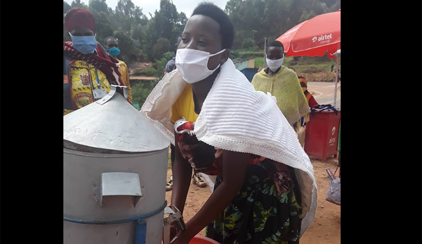 Residents line up to wash hands at Miyove Health Centre in Gicumbi District. / Photo: Lydia Atieno.