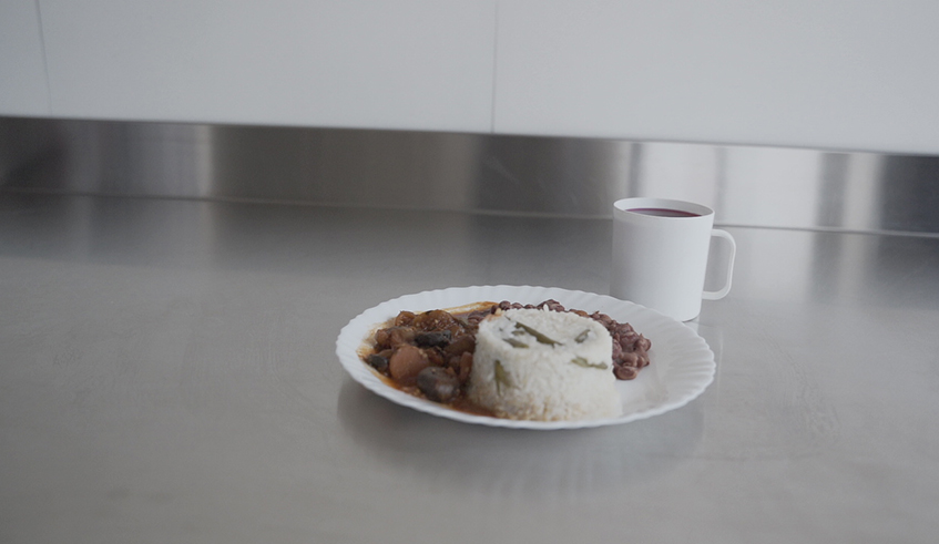 A Solid Africa volunteer makes a meal in the kitchen. / Photo by Gad Nshimiyimana