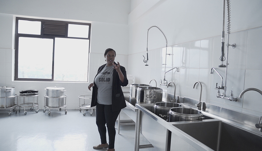 A Solid Africa volunteer makes a meal in the kitchen. / Photo by Gad Nshimiyimana