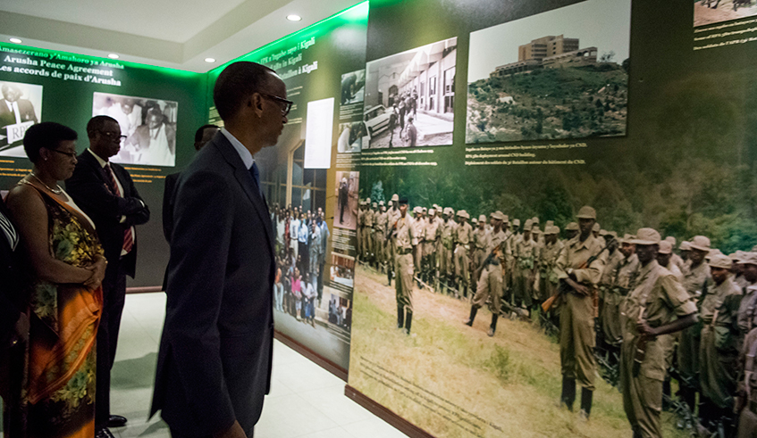 President Kagame looks at a picture of the famous â€˜600 RPA soldiersâ€™, who constituted RPAâ€™s 3rd Battalion, during a briefing shortly before they were deployed to Kigali under the Arusha Peace deal. The agreement would later collapse when the then government started the Genocide against the Tutsi. In this photo, the President was touring the Campaign Against Genocide Museum at the Parliamentary Buildings in Kimihurura which he inaugurated on the same day in December 2017. / Photo: Village Urugwiro.