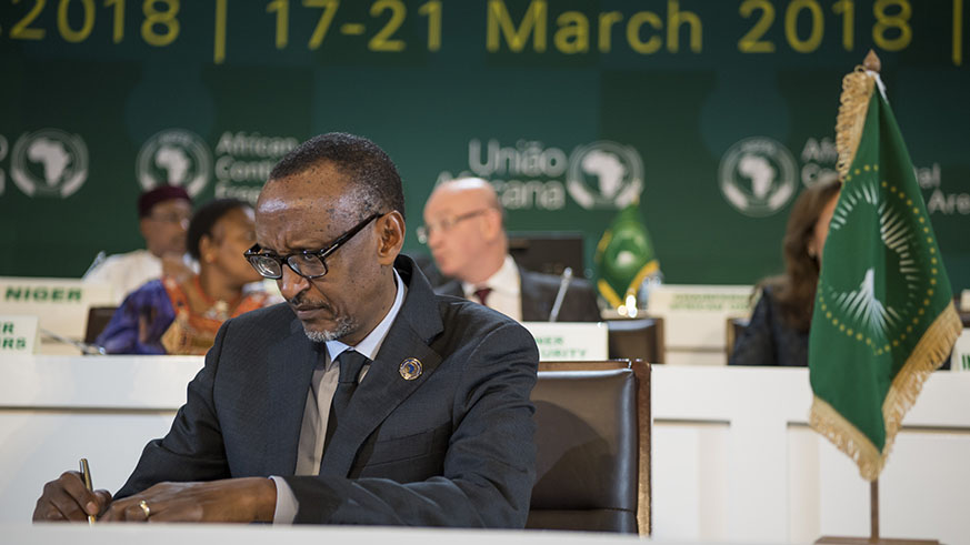 President Paul Kagame signs the three historic instruments at the 10th Extraordinary Summit of the Heads of State and Government of the African Union at the Kigali Convention Centre last month. Courtesy.