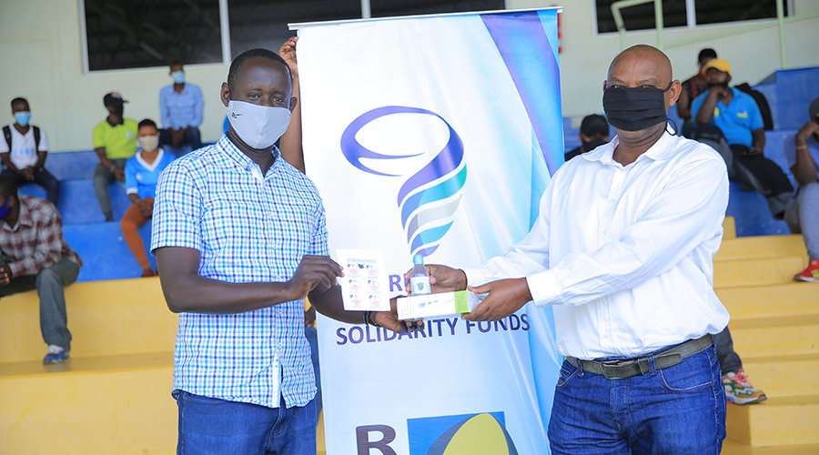 Guy Rurangayire (L), the acting Director of Sports at the Ministry of Sports, attended the event to distribute the donations to rugby players, referees and coaches at Kigali Stadium on Saturday, July 4. 