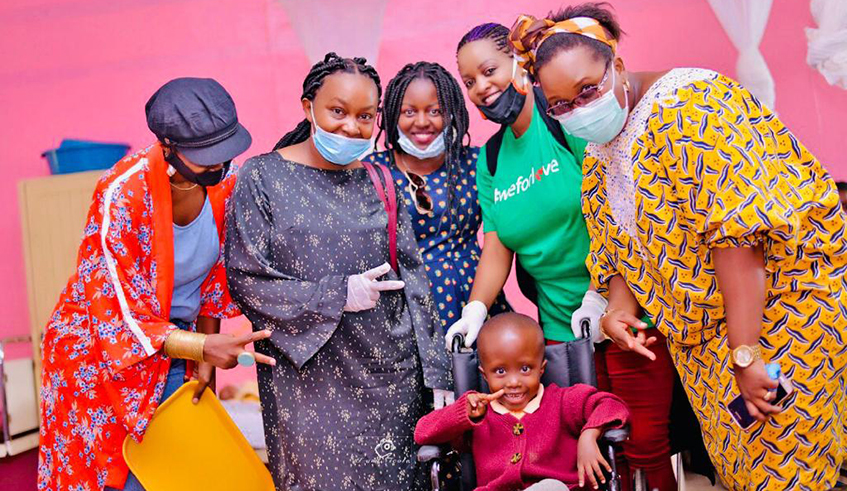 Rapper Grace DaQueen (3rd from left) and her friends pose for a photo with little Gaudance, also known as Gogo. / Courtesy. 