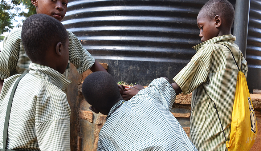 Students drink water at Groupe Scolaire Rweru in Bugesera District. Public and government aided schools have requested to be charged lower prices on water they consume. / Sam Ngendahimana.