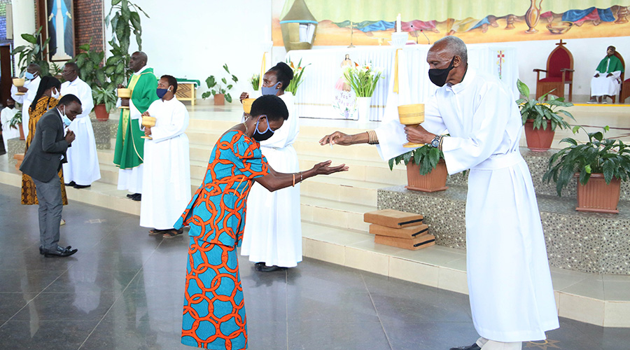Clerics serving holy communion during a mass at Regina Pacis Catholic Church on Sunday, July 19, 2020. / All photos by Craish Bahizi