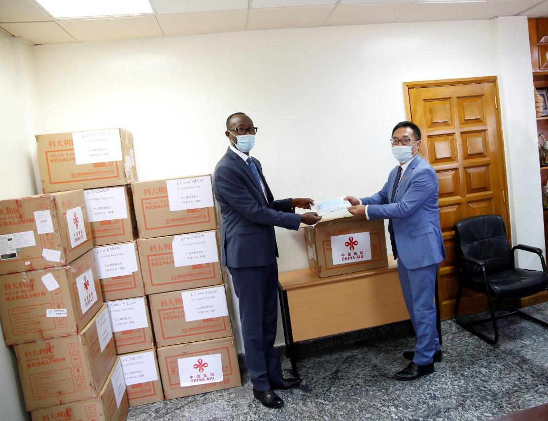 Sosthene Cyitatire, Secretary General of Senate, receives face masks handed over by Wang Jiaxin, Economic and Commercial counselor at the Embassy of China to Rwanda