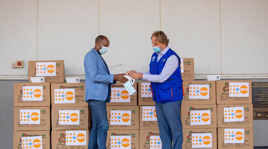 Dr Sabin Nsanzimana, the Director-General of Rwanda Biomedical Center receivesu00a0medical donations from Mark Bryan Schreiner, the UNFPA Representative in Rwanda. 