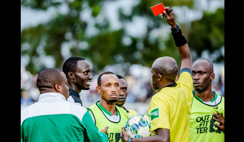 Former SC Kiyovu assistant coach Djabir Mutarambirwa (C) is shown a red card after he was involved in a fight with APR forward Christophe Bukuru (on his left) during a league match at Kigali Stadium last season. / Courtesy.