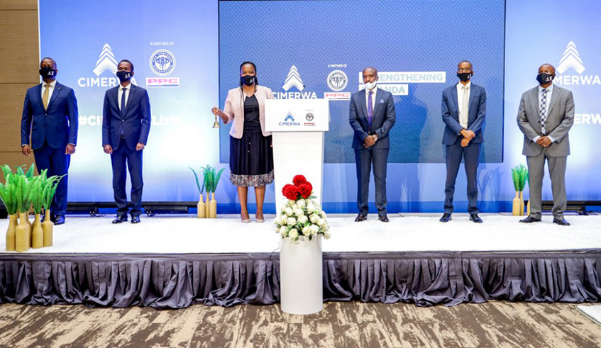 Clare Akamanzi, the chief executive of Rwanda Development Board (centre), flanked by other officials, rings the bell as CIMERWA lists its shares on the Rwanda Stock Exchange on Monday, August 3. The cement manufacturer becomes the 10th company to trade on the local bourse. / Photo: Courtesy.