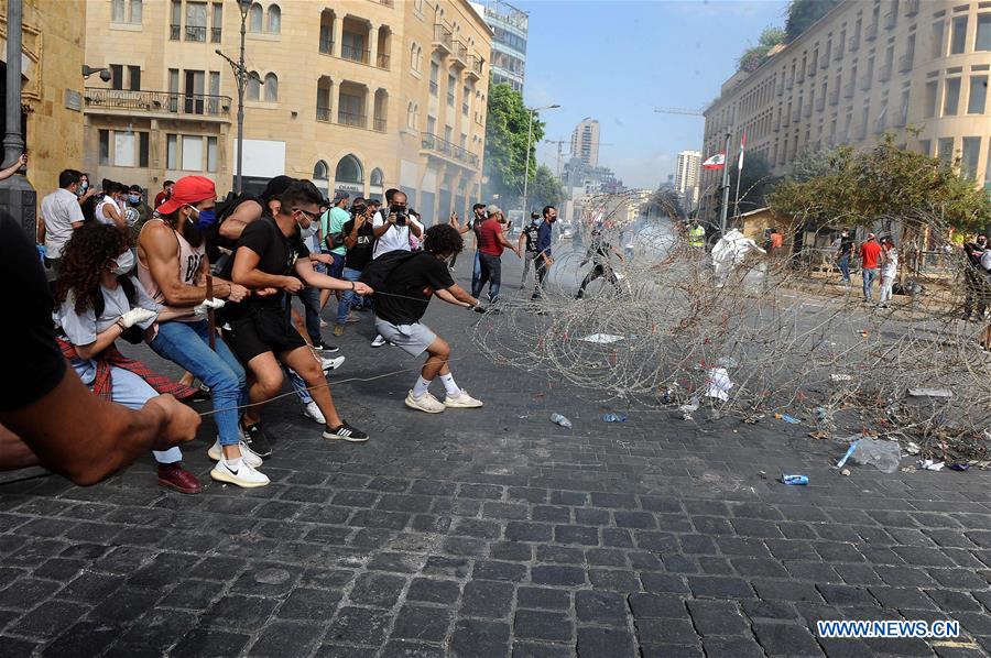 Protesters try to storm the parliament building in downtown Beirut, Lebanon, on Aug. 8, 2020. A Lebanese police officer was killed and 142 people were injured on Saturday in clashes during protests against the ruling class in downtown Beirut, days after massive explosions rocked the Lebanese capital that killed at least 158 and injured 6,000 others, LBCI TV channel reported. 