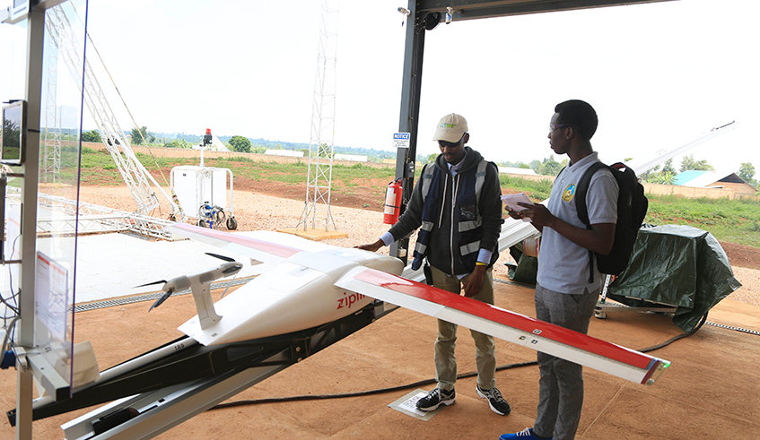 Zipline technician, Edison Niyomurinzi, explains to a journalist the process of how drones supply blood to hospitals. Rwanda is keen on securing investments for its proposed drone operations centre to host, among others, drone manufacturing and training. / Photo: Sam Ngendahimana. 