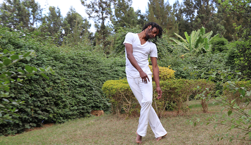 Abdoul Mujyambere rehearsing  in preparation for his performance  for the Africalia project at his studio  garden in Nyamirambo, Kigali.  