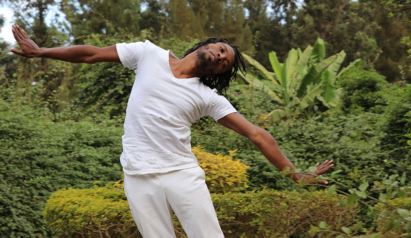 Abdoul Mujyambere rehearsing  in preparation for his performance  for the Africalia project at his studio  garden in Nyamirambo, Kigali.  