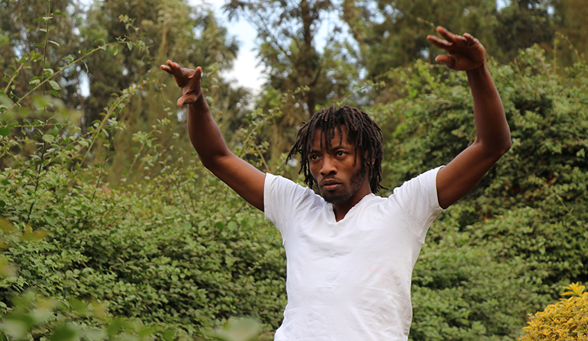Abdoul Mujyambere rehearsing  in preparation for his performance  for the Africalia project at his studio  garden in Nyamirambo, Kigali.  